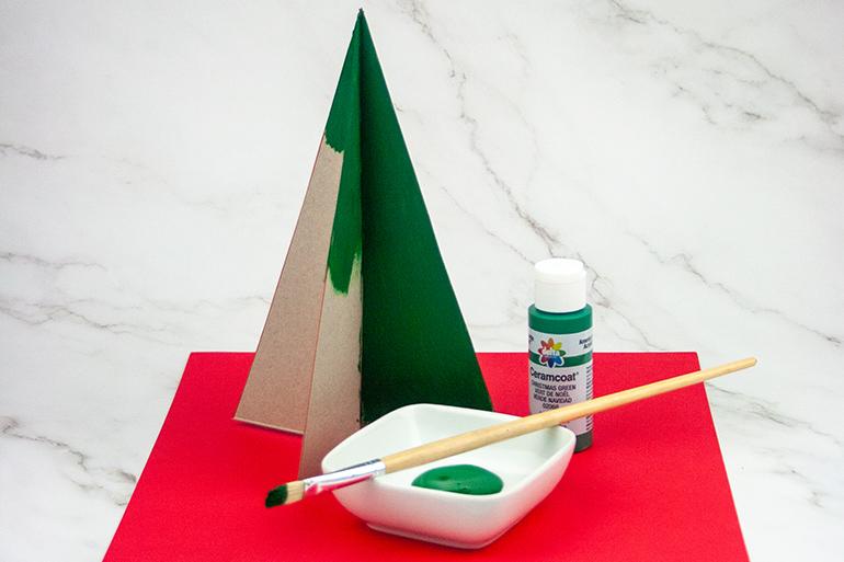 A paper tree in the midst of being painted
