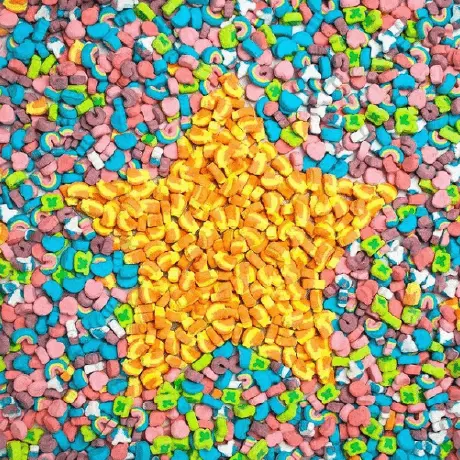 A pile of Lucky Charms™ with a golden star made of the cereal in the middle.