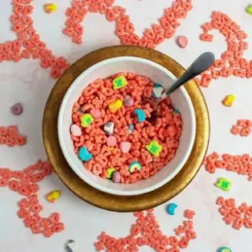 Instagram post featuring bowl of Fruity Lucky Charms™ surrounded by decorative cereal design. - Link to social post