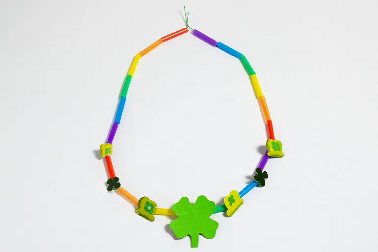 A completed rainbow colored Lucky Charms™ Good Luck Charm Necklace on a white background.